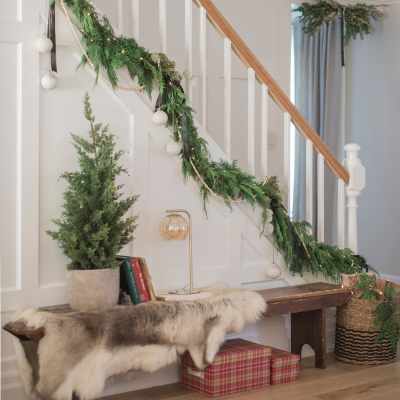 vintage holiday decor in designer home with stairway garland